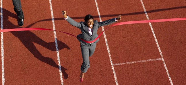 Businesswoman Crossing the Finish Line Ahead of Businessmen